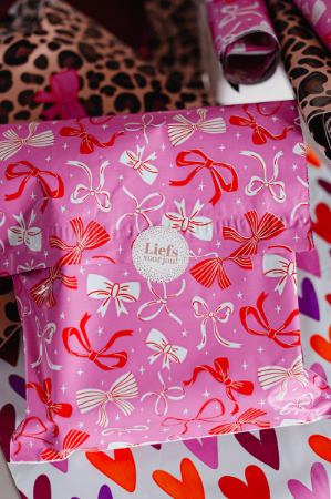 Webshopverpakking roze met strikjes - verzendzak 25x33+7cm