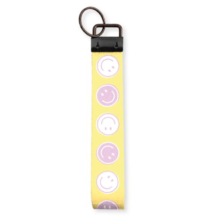 Gele stoffen polssleutelhanger met lila en witte smileys